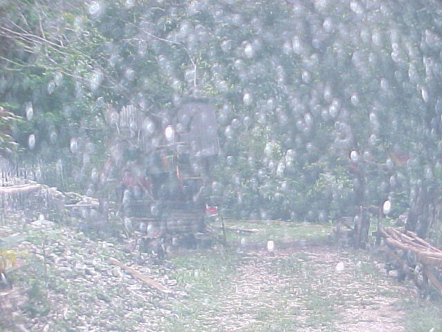 Sorry about the rain drops on the windshield. Here is your final turn to the right. There is a little bamboo building, and your