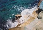 Waves crash at the castle