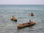 Fisherman bringing in their catch on the beach by EZ