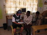 Shorty talks to the Head Teacher Mrs Myrie trying to agree away to clear the computer donations at Customs with no charge to the