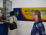 Mrs Myrie, the Headteacher and Shorty sort out the paperwork to clear the goods