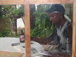 Junior enjoys the Reggae Music books on the terrace whilst we design his show flyers